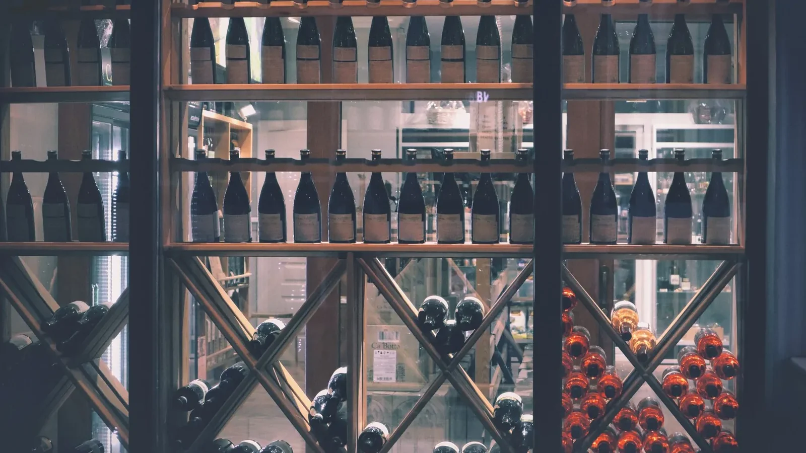 A beautifully arranged wine display in a market setting, featuring diverse bottles