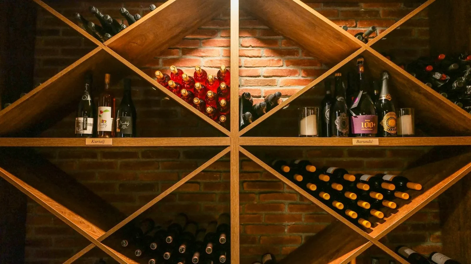 A beautifully organized wine cellar with wooden shelves displaying a variety of wine bottles