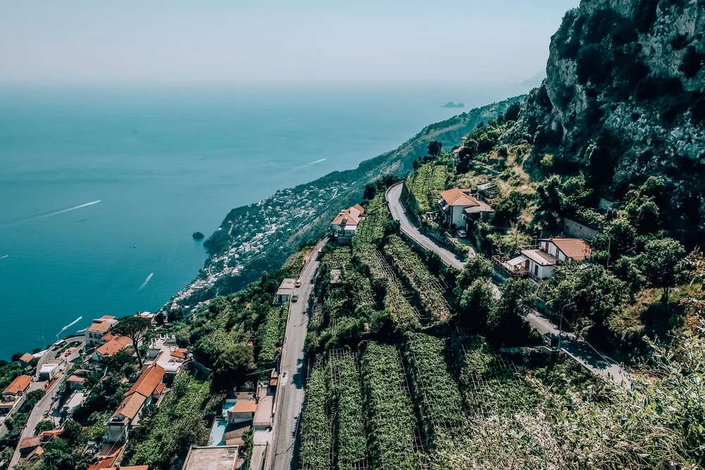 A coastal town overlooking the sea with terraced fields