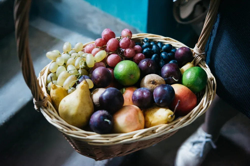 A colorful fruit basket with grapes, limes, and pears, perfect for a fresh and healthy lifestyle image