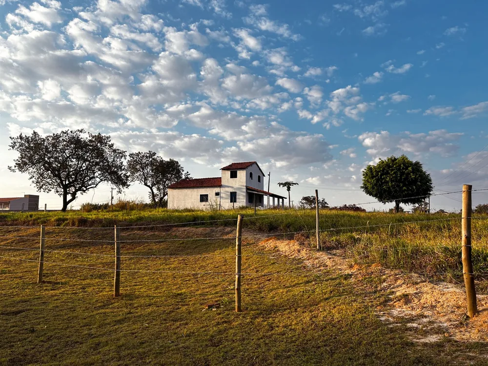 A countryside house with fluffy clouds and landscape