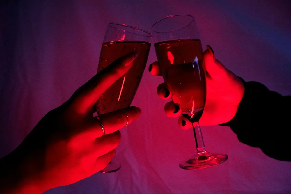 A couple of people holding glasses of wine