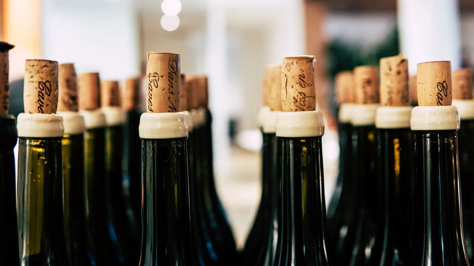 A detailed shot of wine bottles corked and ready for storage, perfect for beverage-themed content