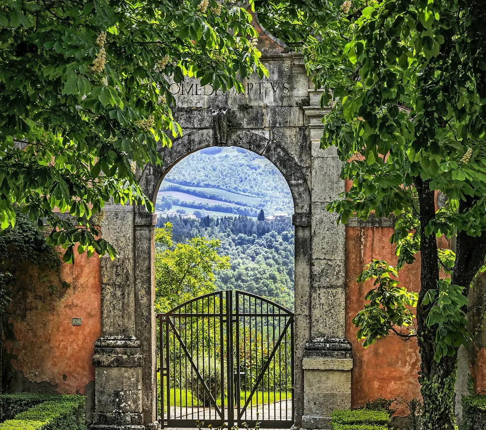 A gate with a mountain view through it