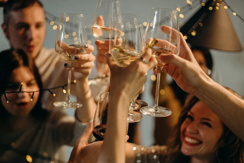 A group of friends joyfully toasting with champagne glasses at a festive celebration