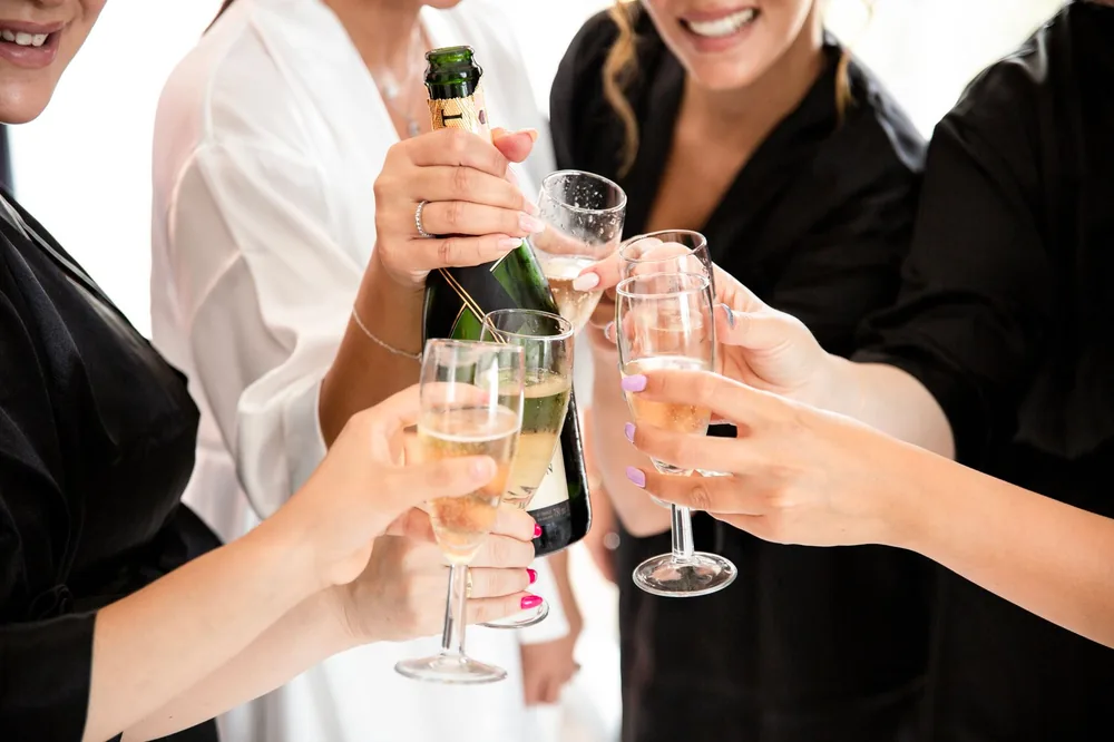 A group of women toasting with champagne glasses in a festive celebration