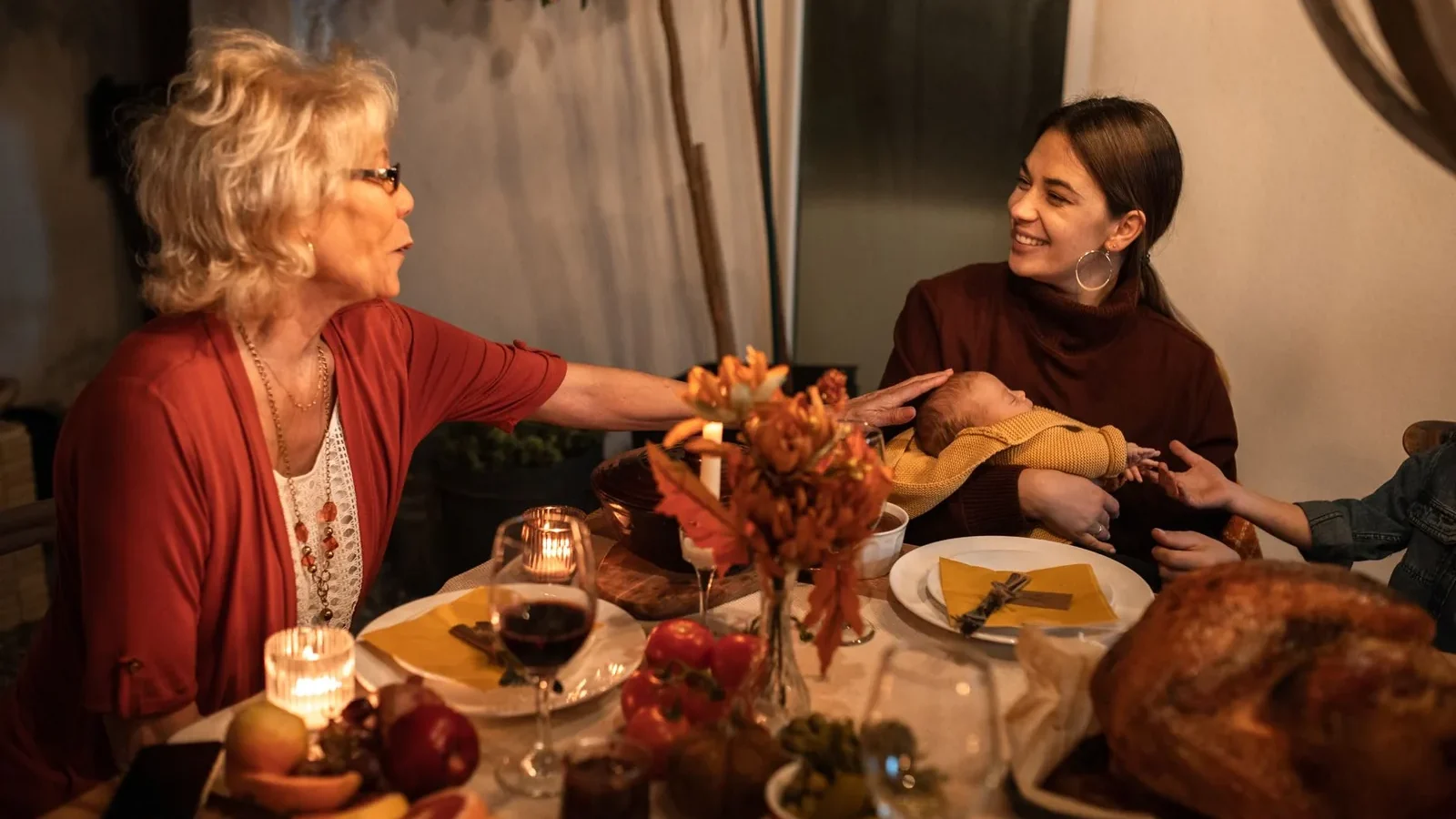 A joyful Thanksgiving dinner with family sharing food and laughter around the table