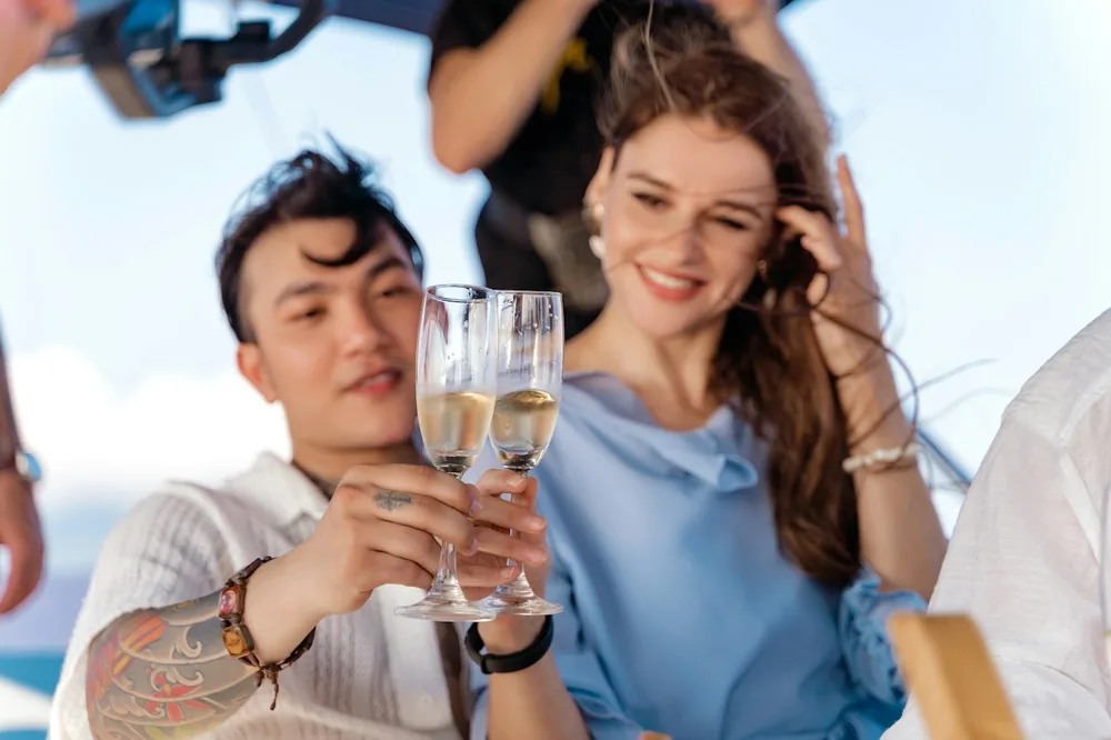 A man holding a glass of champagne next to a woman