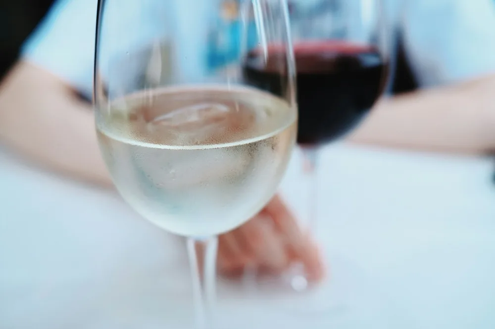 A person holding a glass of wine