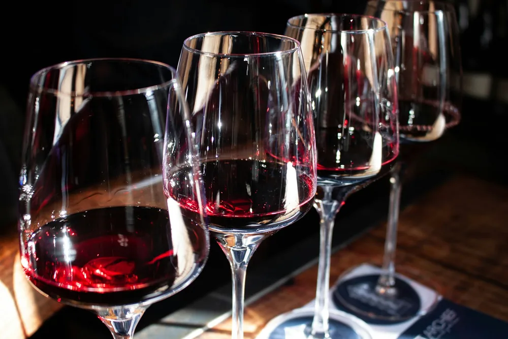 A row of wine glasses sitting on top of a table
