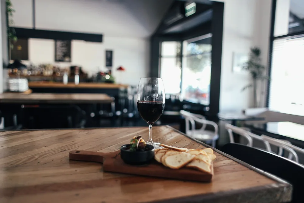 A rustic kitchen setting with wine and bread, creating a cozy and elegant atmosphere