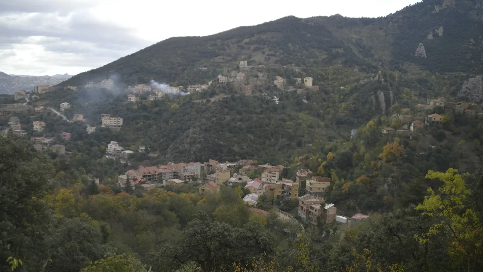 A small town nestled in the mountains surrounded by trees