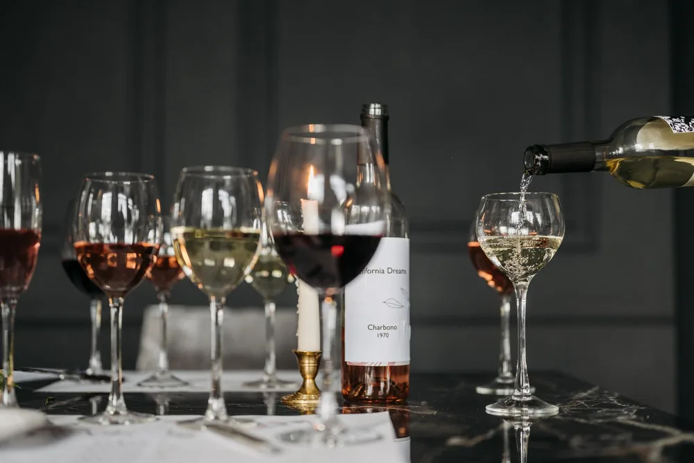 A sophisticated wine tasting arrangement featuring different wine glasses on a dimly lit table