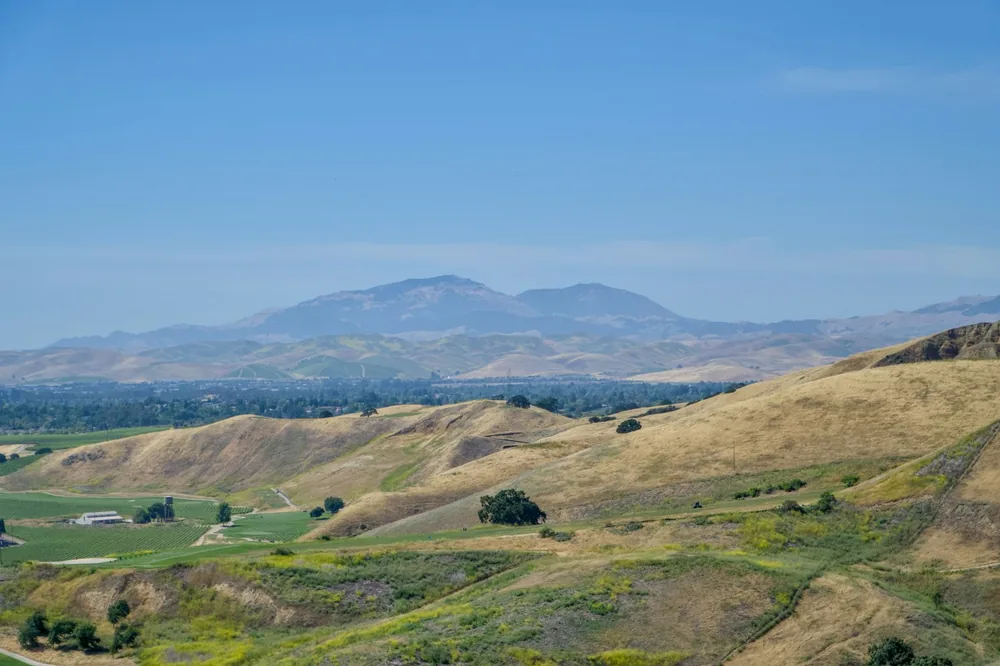 A valley with mountains in the background