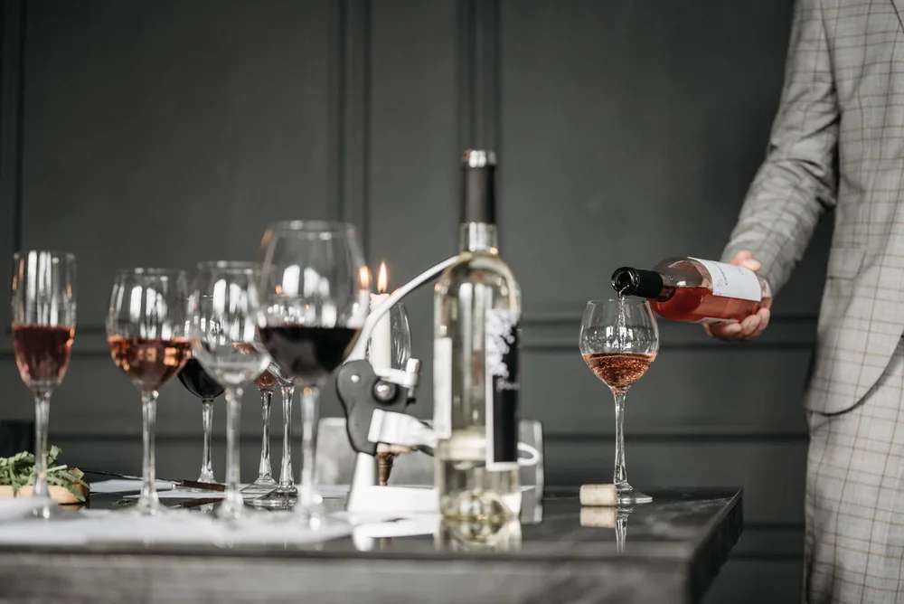 A wine tasting session with a sommelier pouring rosé into a glass