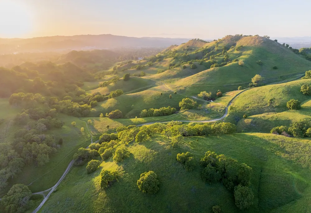 Aerial landscape of Altamont Pass, California showcasing rolling hills and sunrise