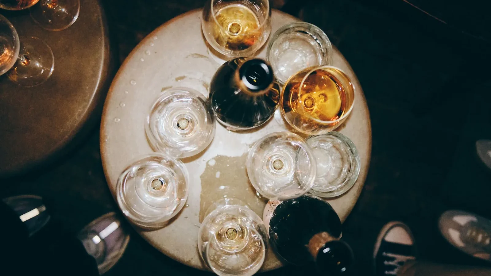 Aerial shot of various glasses with drinks on a round table, ideal for nightlife themes