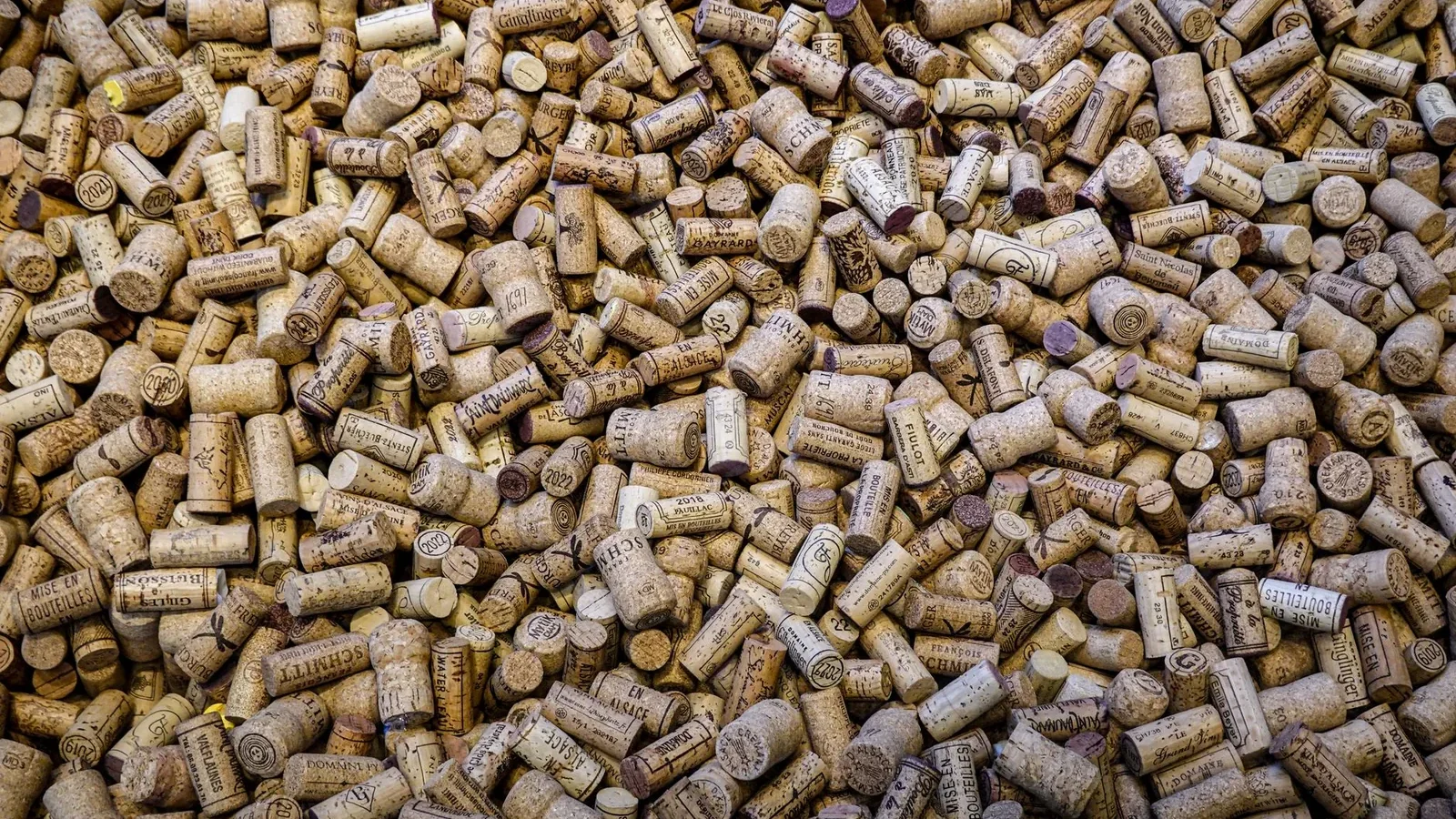 An overhead view of numerous wine corks forming a textured and intricate background