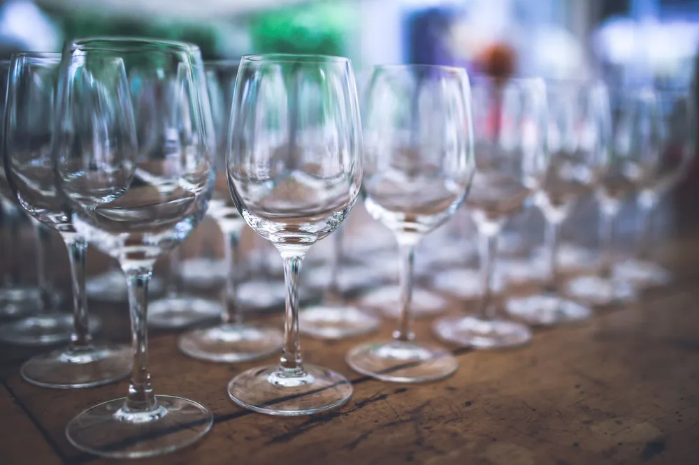 Arrangement of empty wine glasses on a rustic wooden table