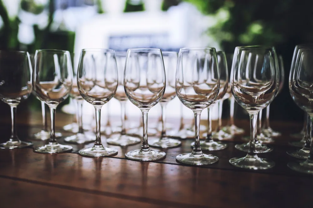 Arrangement of wine glasses on a wooden table, perfect for celebrations and events