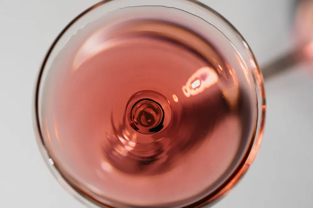 Artistic close-up of rosé wine captured from above in a wine glass