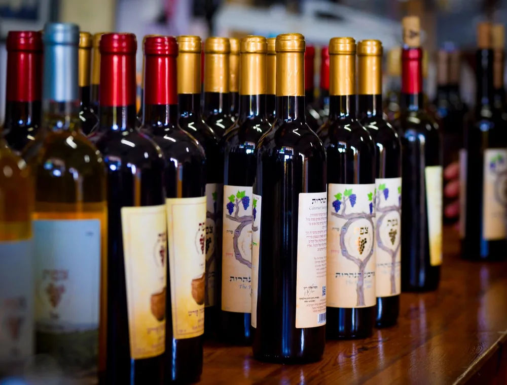 Assorted wine bottles on display at a winery showcasing various labels and colors