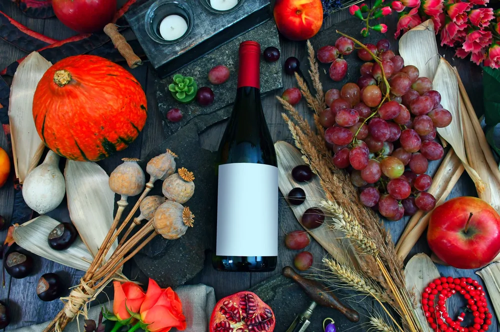Autumn still life featuring wine, fruits, and seasonal decor. Perfect for festive themes