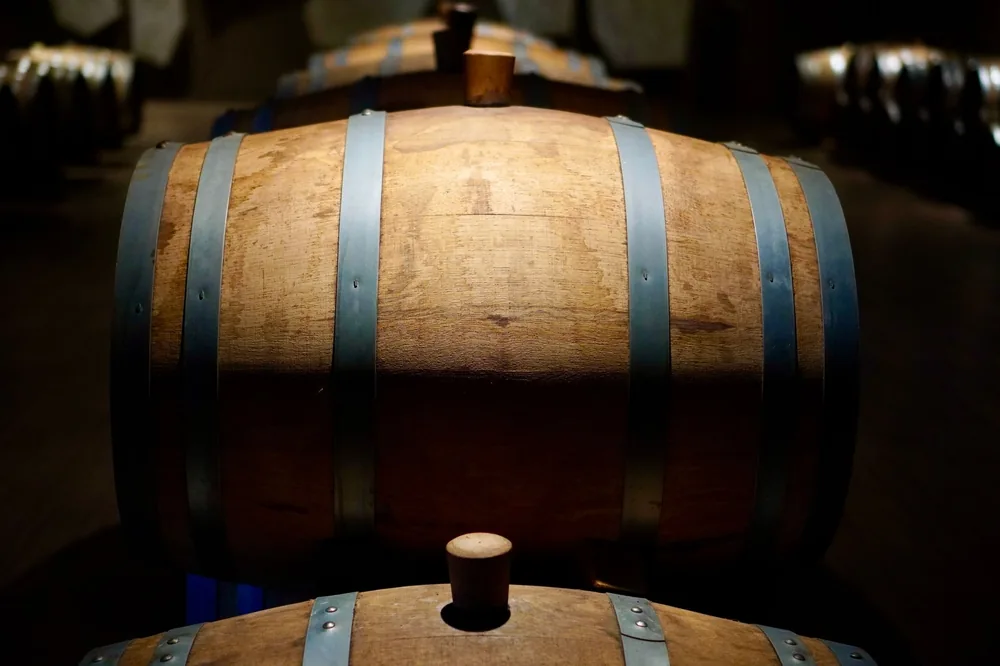Barrels in a shadowed winery cellar, perfect for wine aging imagery