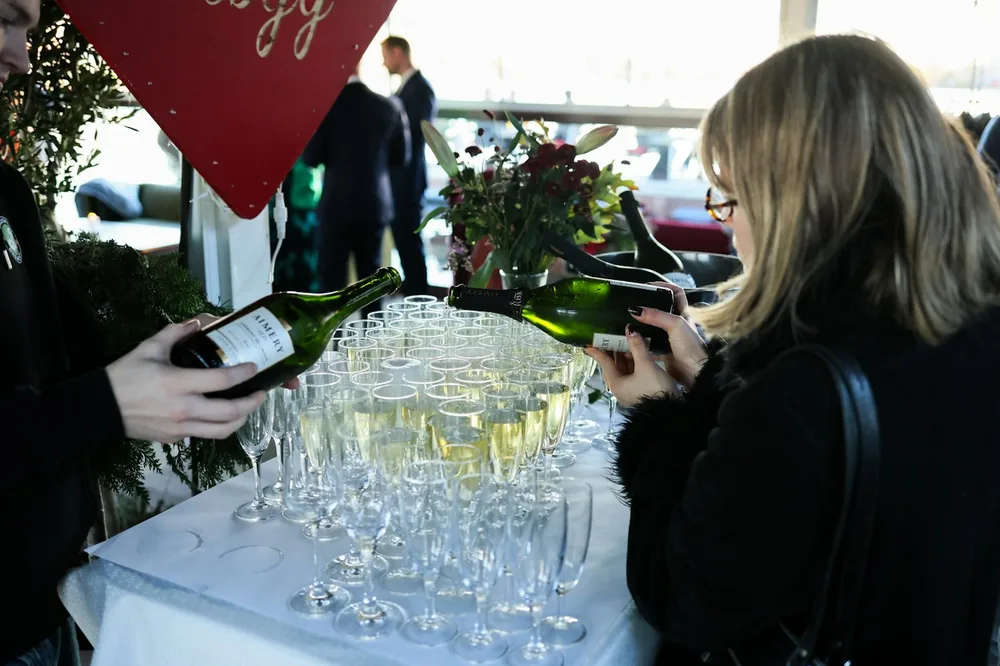 Bartender pouring champagne into glasses at event