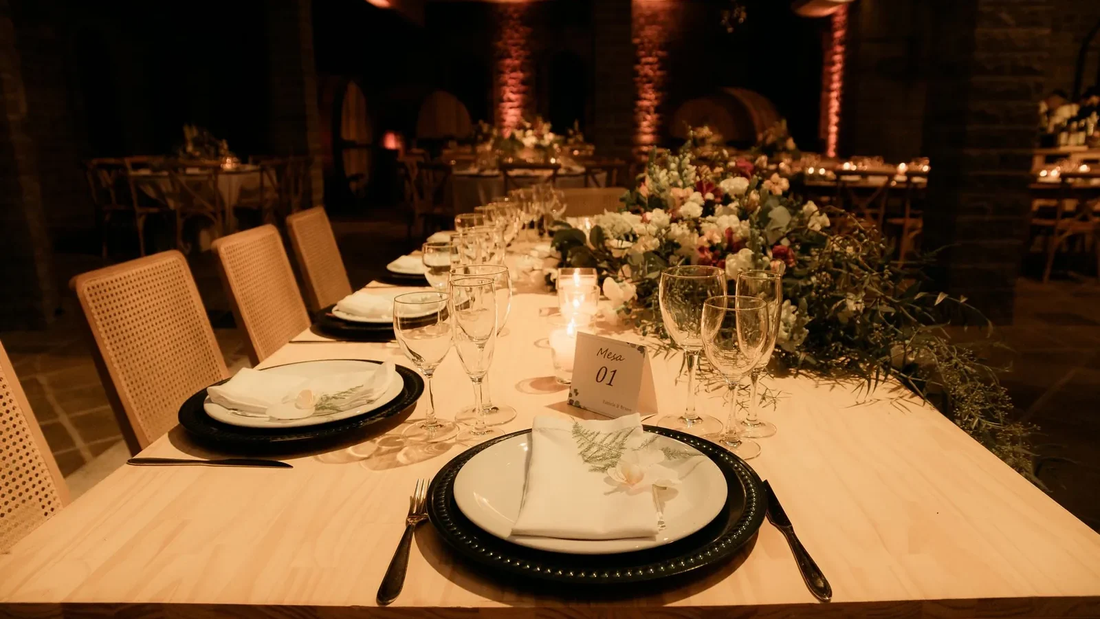 Beautifully decorated dinner table with floral centerpiece, ideal for weddings or upscale events