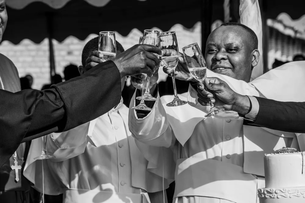 Celebratory toast with champagne glasses in a black and white setting