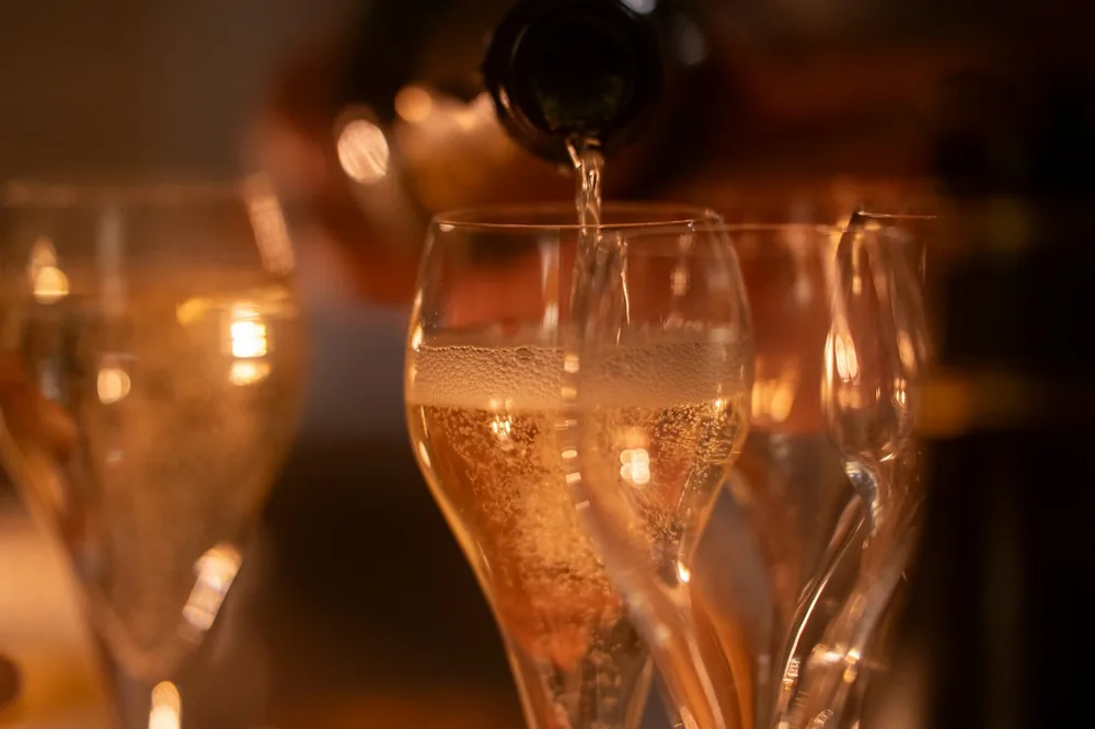 Champagne being poured into elegant glasses