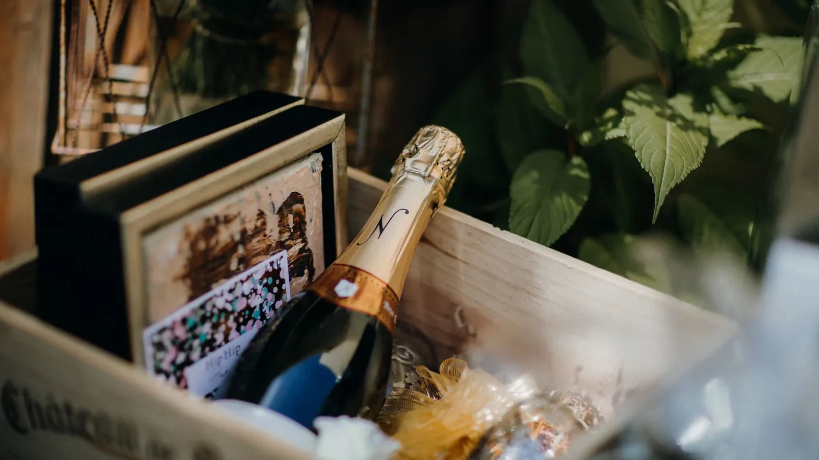 Champagne bottle in a stylish wooden gift box with decorative elements