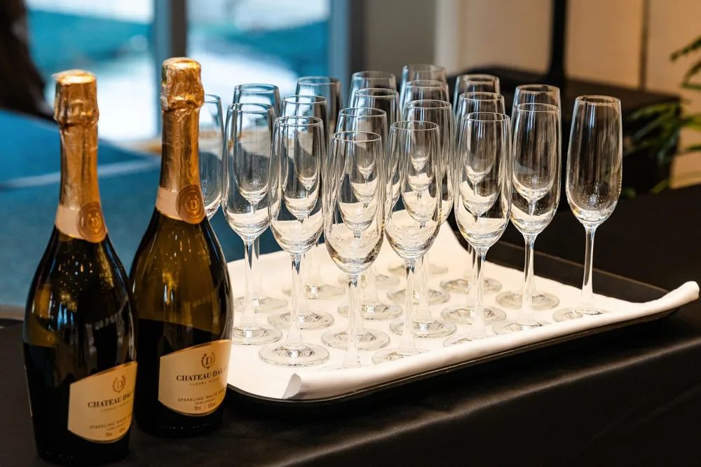 Champagne bottles with glasses on a tray, perfect for upscale celebrations and parties