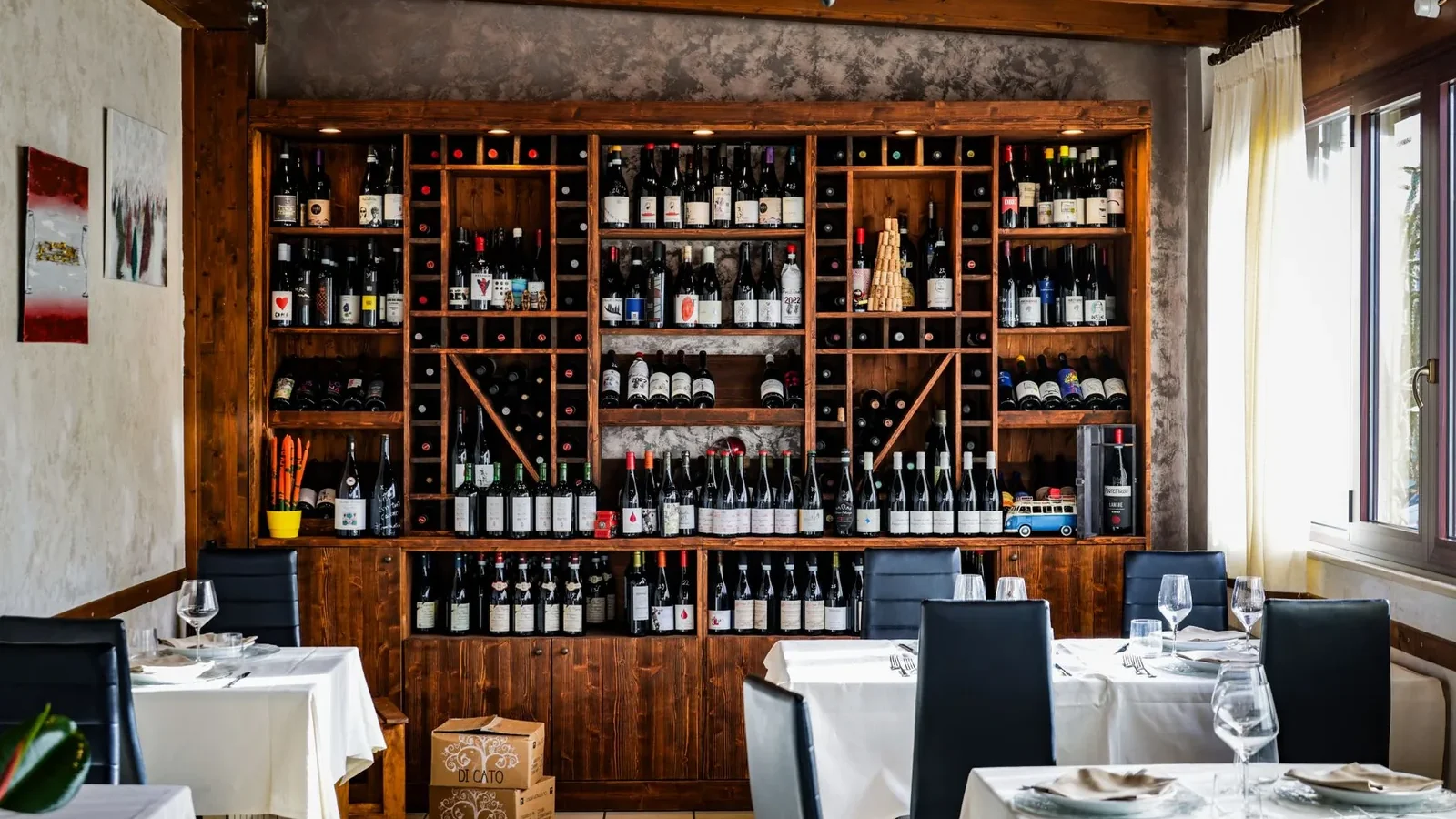 Chic restaurant interior with a comprehensive wine collection on display