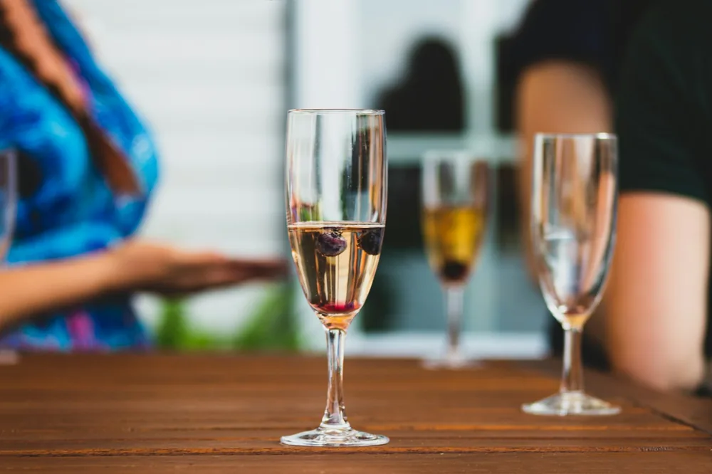 Clear wine glass on brown wooden table