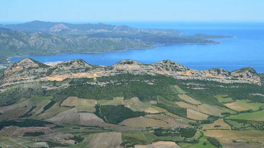 Coastal landscape with mountains and open fields