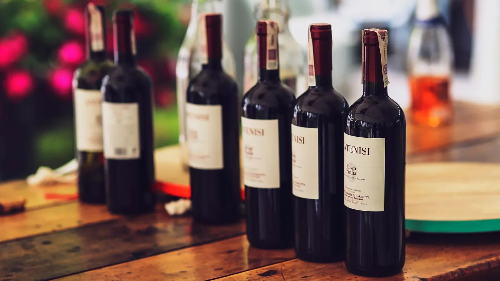 Cozy dinner setup featuring multiple wine bottles on a wooden table, ideal for special occasions
