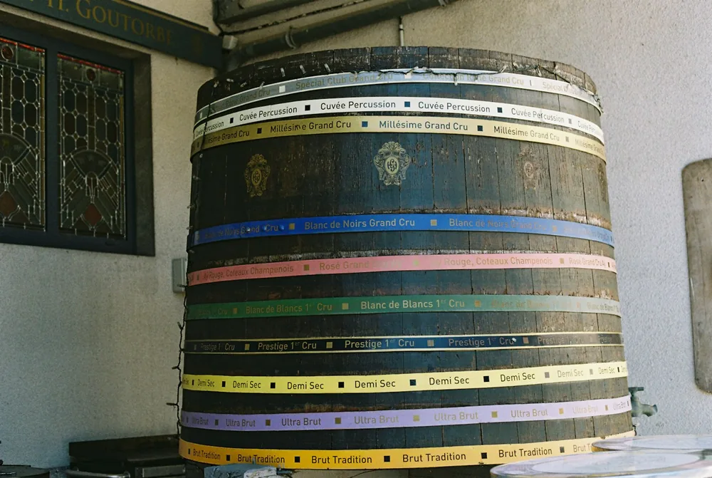 Decorated wooden barrel with colorful bands outside building
