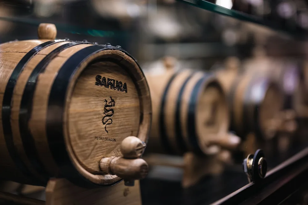 Detailed view of aging barrels in a distillery, showcasing wine production process