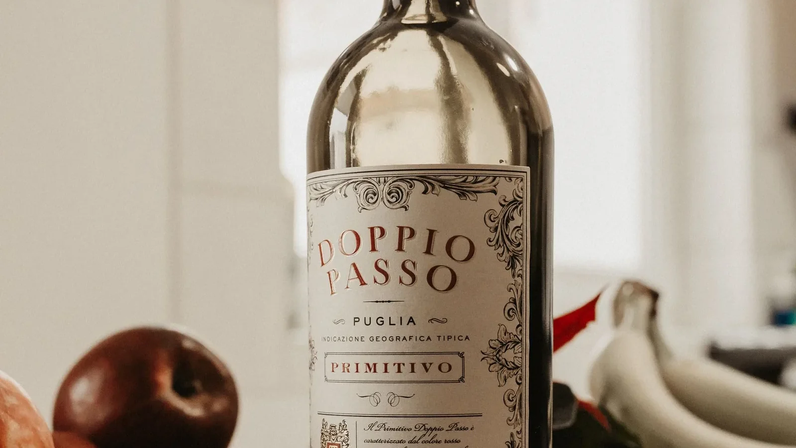 Doppio Passo Primitivo wine bottle and fresh fruits on a sleek tabletop