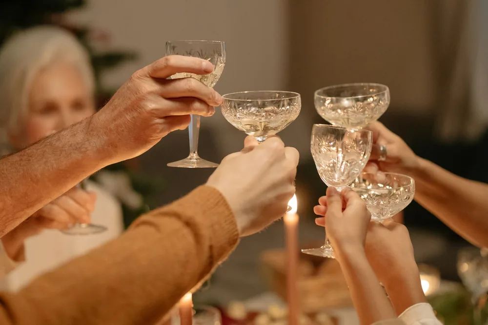 Family members toasting with crystal glasses, celebrating a festive holiday gathering