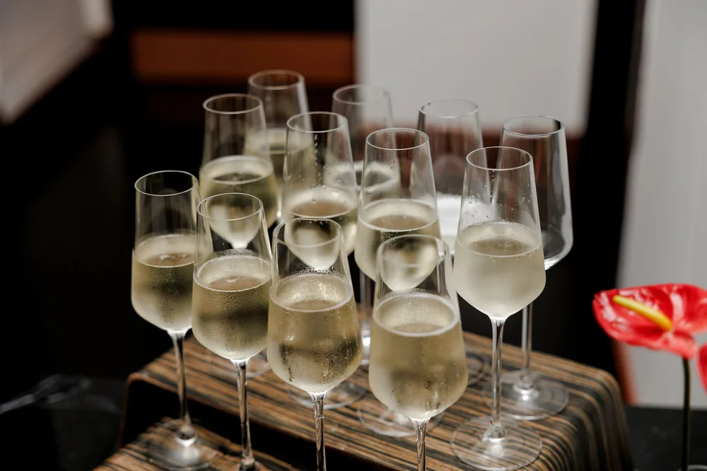 Filled champagne glasses on a tray, perfect for celebrations and events