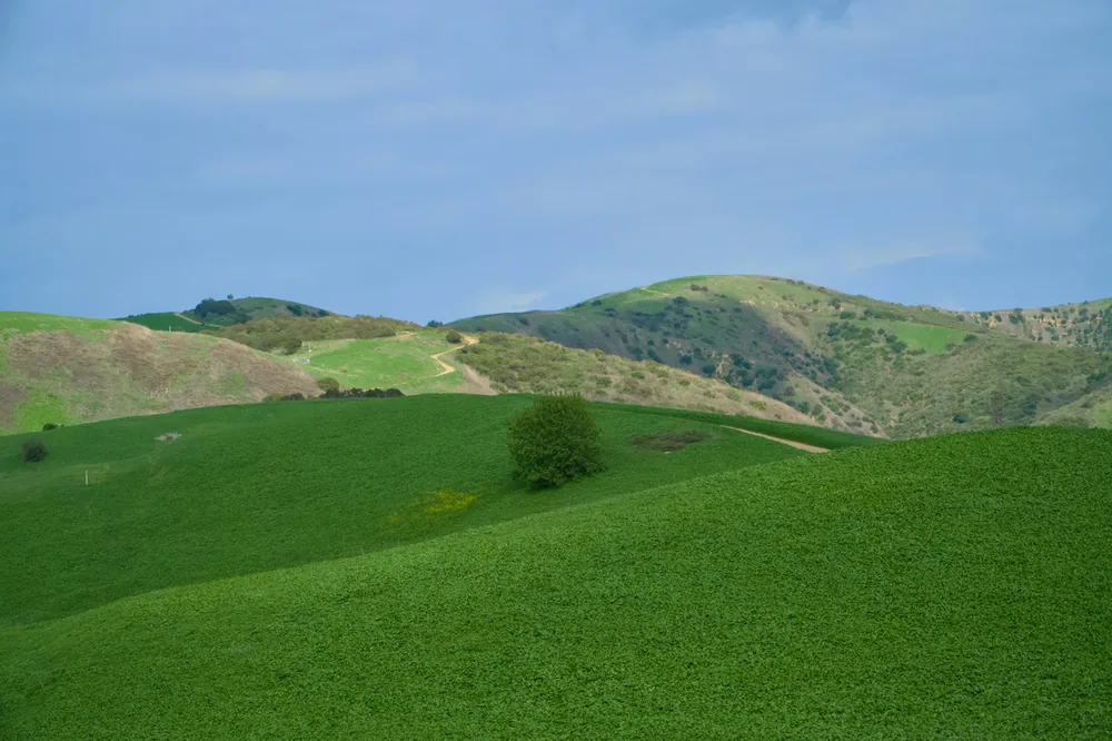 Green hills and blue sky create a peaceful landscape
