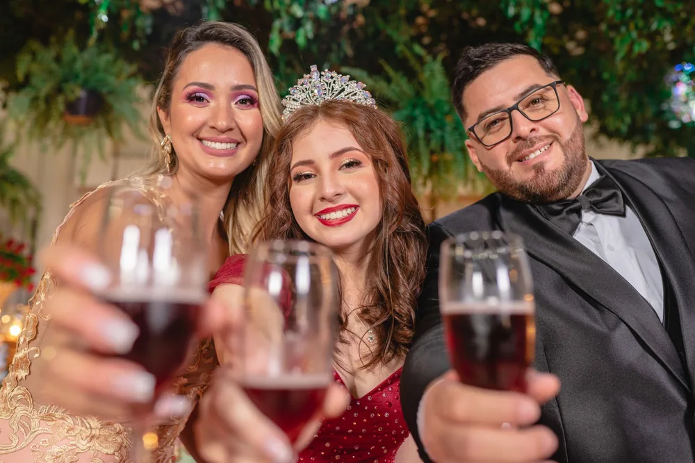 Group of elegantly dressed friends toasting with champagne glasses at a festive celebration