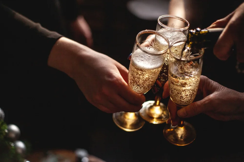 Hands toasting with champagne glasses, capturing celebration and joy