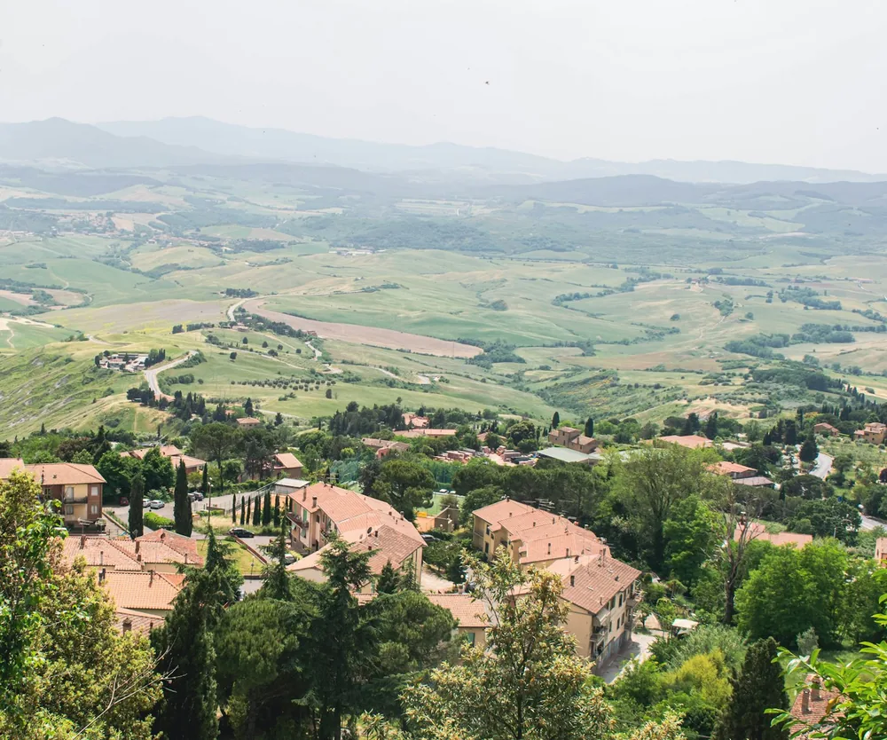 High-angle view over village houses into vast countryside valleys