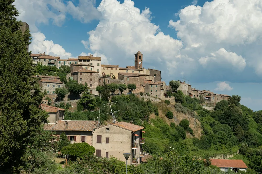 Hilltop village with stone buildings and a clock tower