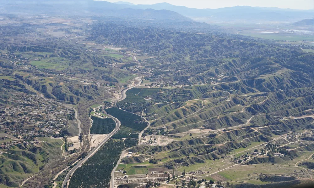 Lush hills with farms and roads weaving through the terrain