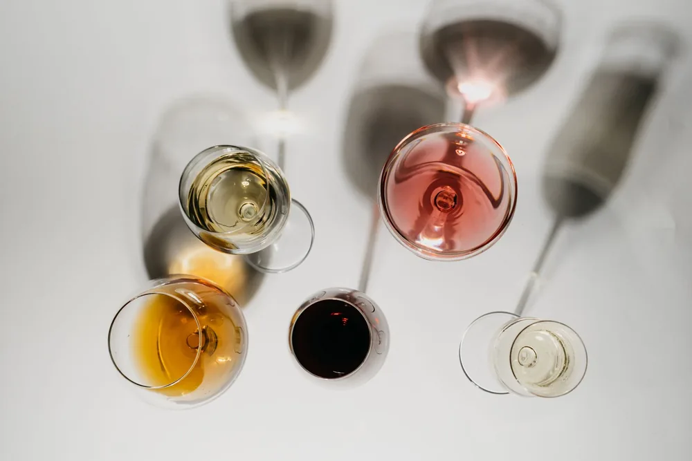 Overhead view of various wine glasses showcasing red, white, and rose wines